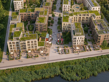 Luftaufnahme eines modernen Wohnquartiers mit begrünten Flachdächern und Innenhöfen neben einem Gewässer